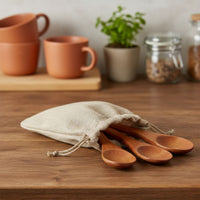 Wooden spice spoons inside Secret Spice Co glass jar